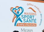 a group of people standing in front of a building named La maison sport santé