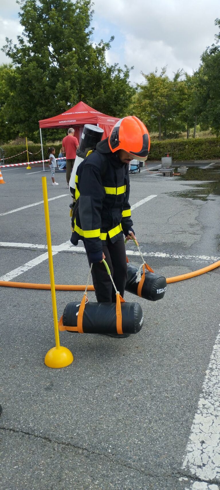 photo pompier- jeune transportant des charges lourdes
